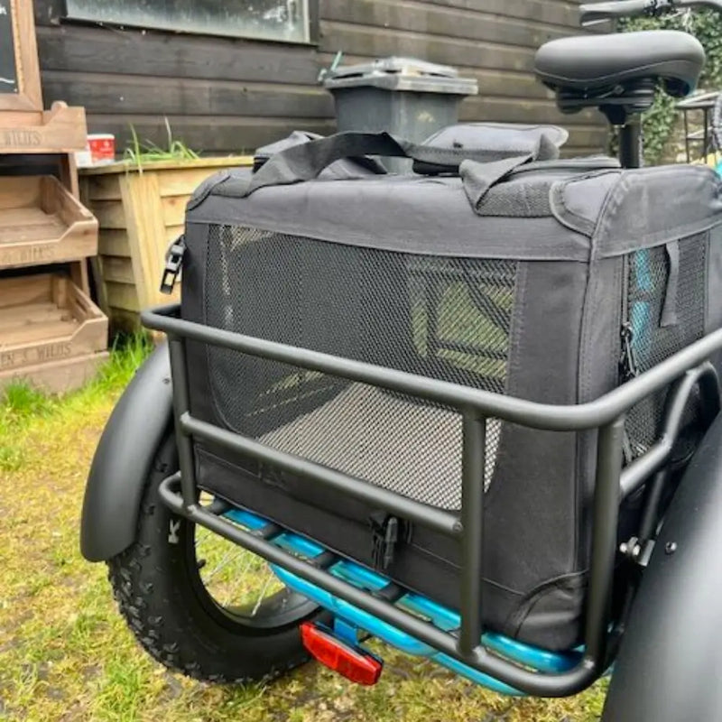 Close-up of the Revom pet carrier on the bike rear rack, showing the mesh visibility panel.