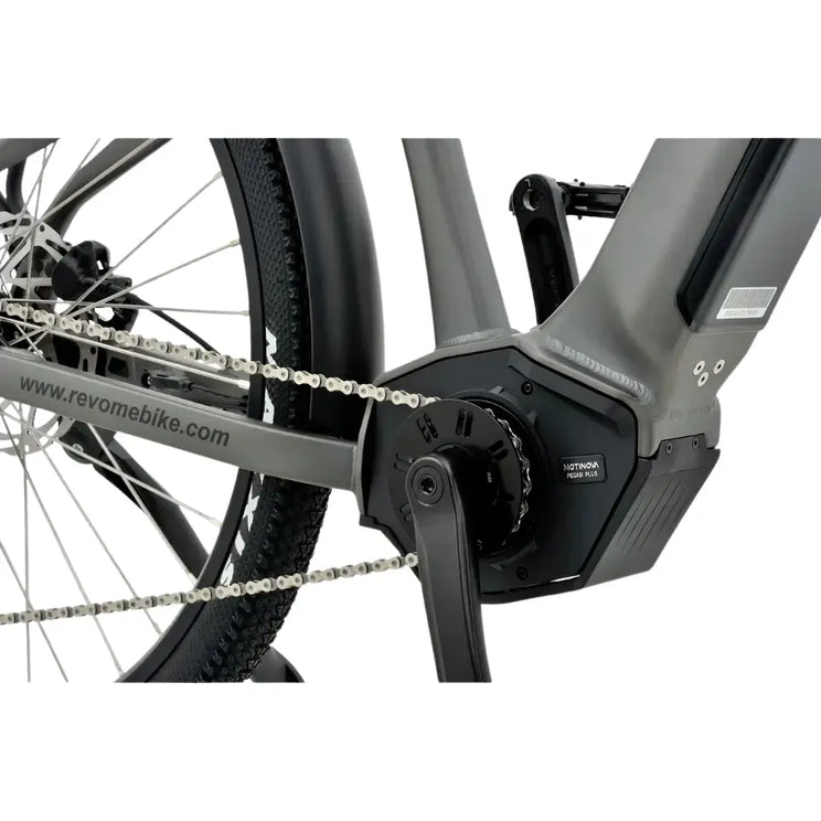 Close-up of the mid-drive electric motor and chain on the Revom S1 ATB bike.
