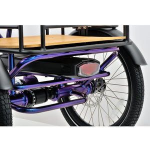 Rear view of the Revom T4 electric cargo tricycle highlighting the rear cargo rack, taillight, and disc brake on the right wheel.