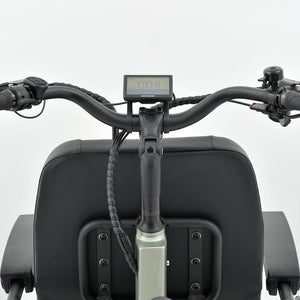 Handlebar view of the Revom T5 electric tricycle showing the LCD display and cushioned grips