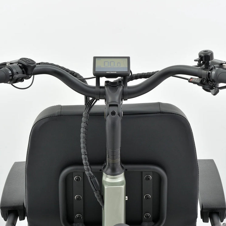 Handlebar view of the Revom T5 electric tricycle showing the LCD display and cushioned grips