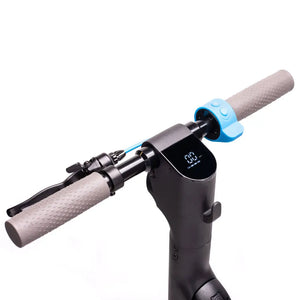 Close-up of Riley RS1 V2 electric scooter handlebars with digital display, brake lever, and blue throttle button.