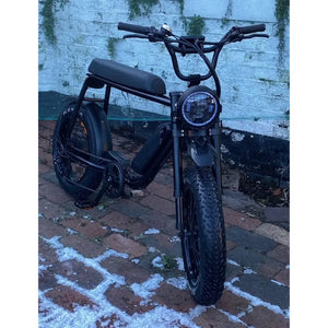 Close-up front view of the Rocket 88X Fat Boy electric bike featuring a circular headlamp and wide knobby front tyre.