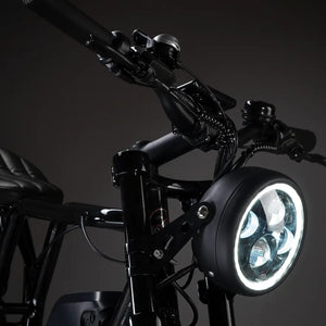 Detailed shot of the round LED headlight on the Rocket GTS 350W electric cruiser.