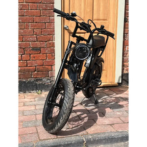 Rocket ST fat tyre electric bike front view with round headlight and thick tyres