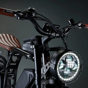 Detailed shot of the round LED headlight on the Rocket SX protected by a black metal mesh grill guard.