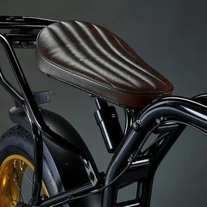 Close-up of the coil-spring suspension shock absorber located under the leather seat of the Rocket SX e-bike.