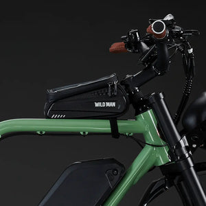 Detail shot of the "Wild Man" waterproof hard-shell storage bag mounted on the green Rocket X frame.