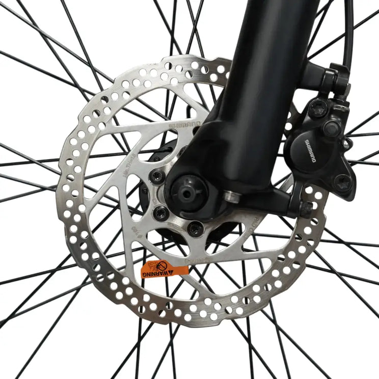 Close-up of the Shimano disc brake rotor and caliper on the front wheel of the Mark2 X-Cross 520.