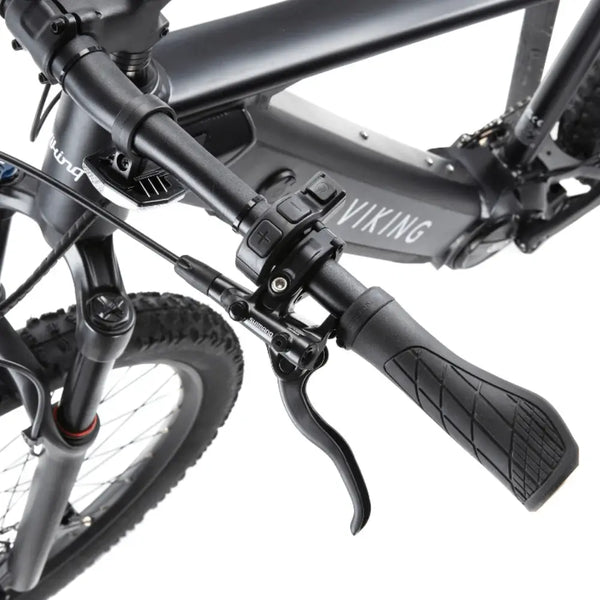 Close-up view of the Viking Pro electric mountain bike handlebar with ergonomic grips, control buttons, and hydraulic brake lever.
