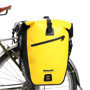 Waterproof rear rack pannier in yellow mounted on a bicycle.