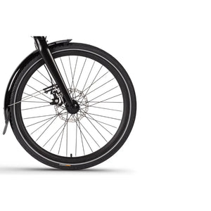 Front wheel view of the Wisper 705 24" Step Through Electric Bike 250W with a disc brake, suspension fork, and fitted mudguard for urban and hybrid use.