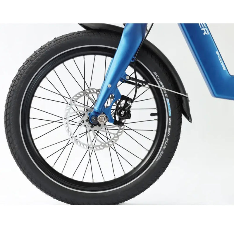 Detailed view of the 20-inch front wheel on the Wisper Tailwind e-bike, featuring a hydraulic disc brake and Schwalbe Big Ben Plus tire.