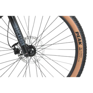 Wisper Tailwind electric bike front wheel close-up with Goodyear tyre and RockShox suspension fork